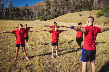 Trainer training kids in the boot camp