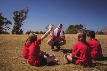 Trainer instructing kids in the boot camp