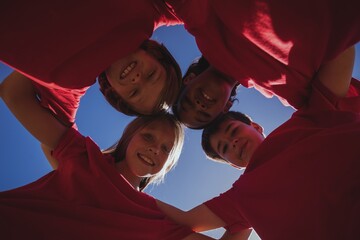 Kids forming huddle in the boot camp