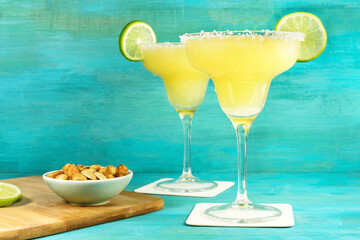 Margarita cocktails on turquoise background with copyspace