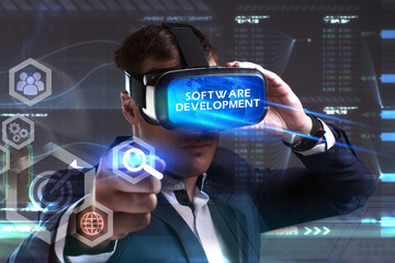 Business, Technology, Internet and network concept. Young businessman working in virtual reality glasses sees the inscription: Software development