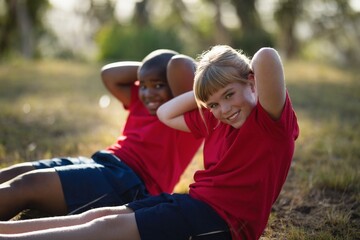 Portrait of happy kids exercising during obstacle course