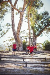 Fototapeta premium Trainer instructing kids during obstacle course training