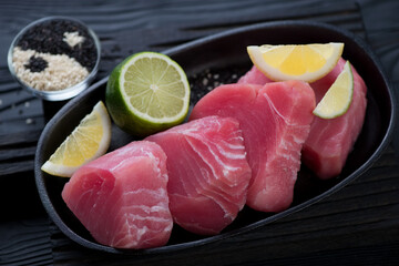 Close-up of a frying pan with slices of raw fresh tuna fillet, selective focus, studio shot