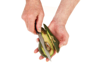 Hands cutting an avocado pear