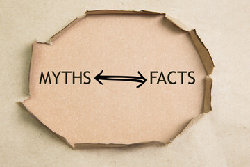 The text Facts vs myths appearing behind torn brown paper