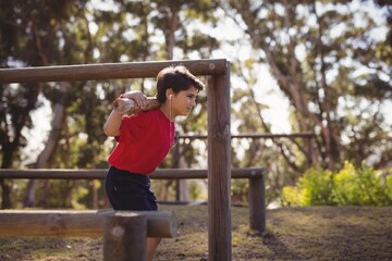 Happy boy exercising with log while listening music