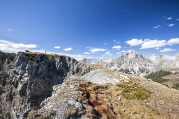 Hiker admires the landscape Ofen Pass Mustair Valley Canton of Grisons Switzerland Europe