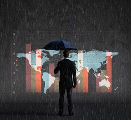 Businessman with umbrella standing over column diagram background. Business, crisis, default concept.