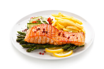 Grilled salmon, French fries and vegetables