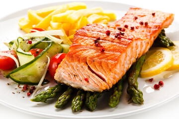 Grilled salmon, French fries and vegetables