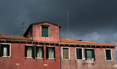 Threatening Clouds and red house