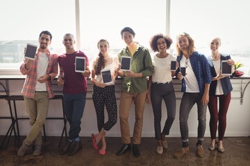 Fototapeta premium Portrait of smiling business team with technology
