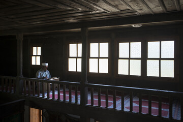 A Man reading al-Quran