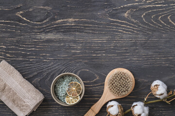 SPA beauty cosmetic products top view on dark wooden table. Professional massage concept. Copyspace