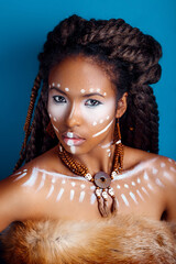 African style woman . Attractive young woman in ethnic jewelry . close up portrait of a woman with...