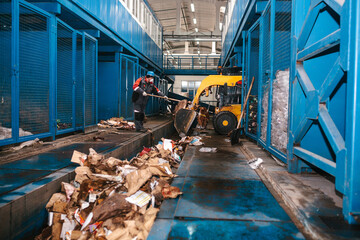 The bulldozer will clean the waste dump. Waste processing plant. Technological process. Business...