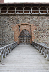 Fototapeta na wymiar Wooden door in the castle and wooden bridge