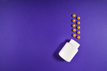 Medical pills vitamins on a colored background with a vial