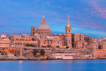 Fototapeta na wymiar Valletta Skylineat at beautiful sunset from Sliema with churches of Our Lady of Mount Carmel and St. Paul's Anglican Pro-Cathedral, Valletta, Capital city of Malta