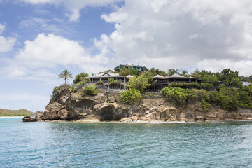 The turquoise Caribbean sea and a tourist resort seen from a boat tour Antigua and Barbuda Leeward...