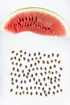 Raining seeds. Beautifully cut watermelon slice. Watermelon on white background. Beautiful ripe watermelon close-up. 