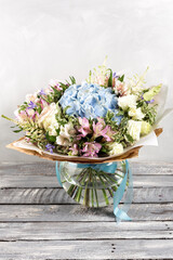 luxurious and elegant bouquet of roses and Other colors flowers on wooden background, copy space.