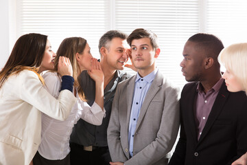 Fototapeta premium Business Colleagues Whispering In The Office
