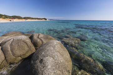 Rocks frame the turquoise water of sea around the sandy beach of Sant Elmo Castiadas Costa Rei Cagliari Sardinia Italy Europe