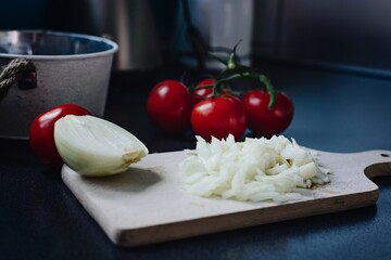 Chopped onion on a wooden chopping board