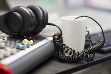 Obraz na płótnie Canvas Headphones With Spiral Cord In Radio Studio