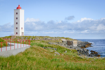 Fototapeta na wymiar Picturesque lighthouse Kjølnes near Berlevåg, Finnmark, Norway