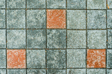 Fototapeta premium Gray concrete pavings on a sidewalk with red elements stones. Abstract background texture
