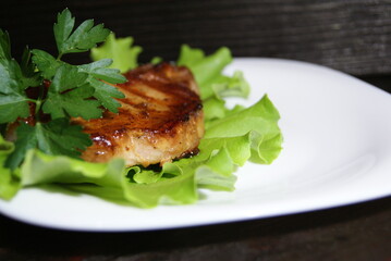 Beef steak on lettuce leaves.