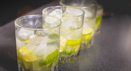 Caipirinha glass with icicle on black background