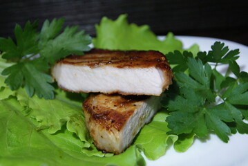 Beef steak on lettuce leaves.