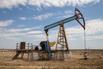 Fototapeta na wymiar Oil pump working in desert of western Kazakhstan