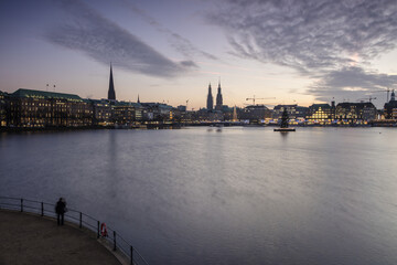 Photographer admires the Inner Alster Lake with the Christmas Tree suspended in its water at dusk Hamburg Germany Europe