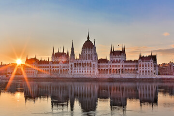 Fototapeta premium Parliament and riverside in Budapest Hungary during sunrise with sunbeams