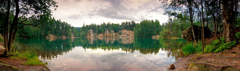 Panorama view of flooded sandstone quarry in the national nature reserve Adrspach-Teplice Rocks. Wonderful lake with crystal clear water and the white sandy beaches. Czech republic, Europe.