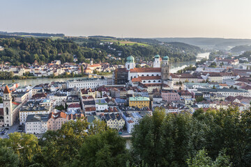 Fototapeta na wymiar Top view of the typical buildings and houses set among green hills and river Passau Lower Bavaria Germany Europe