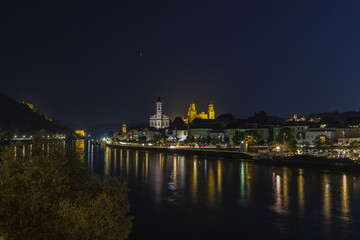 Fototapeta premium Night view of the old city with typical buildings and houses reflected in the river Passau Lower Bavaria Germany Europe