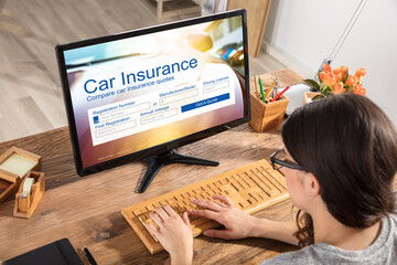 Woman Filling The Car Insurance Form On Computer