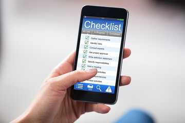 Smart Phone In Hands With Check List