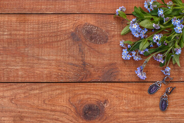 brown wooden background with forget-me-nots