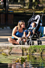 Mother and son by the lake on sunny day