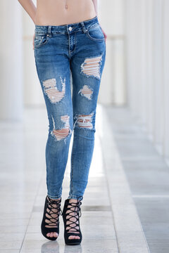 girl in jeans on legs of young woman in fashionable shoes