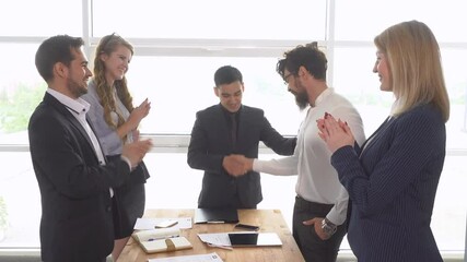 business meeting. Handshake of businessman at the conclusion of the transaction. Successful negotiations of a group of young businessman in the office of the company