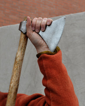 Man's hand on ancient broadaxe 1
