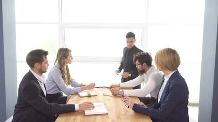 chief holds a meeting in the office. Business meeting and negotiations of young businessman. Colleagues discuss the startup